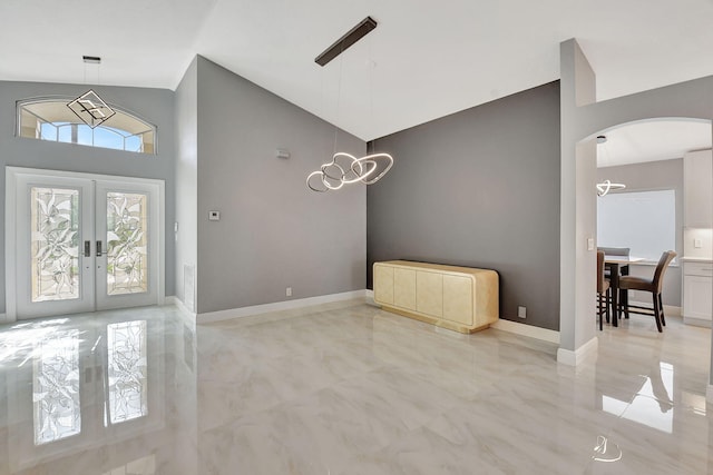 entrance foyer with lofted ceiling and french doors