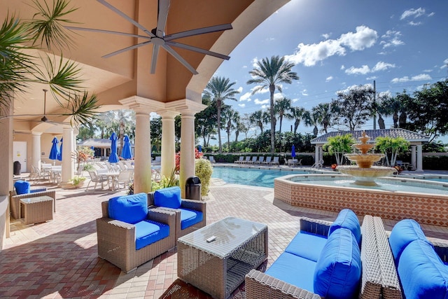 view of patio with a community pool, pool water feature, and an outdoor hangout area