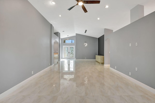 unfurnished living room featuring ceiling fan, vaulted ceiling, and french doors