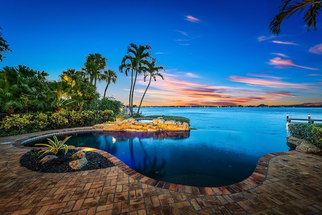 pool at dusk with a water view