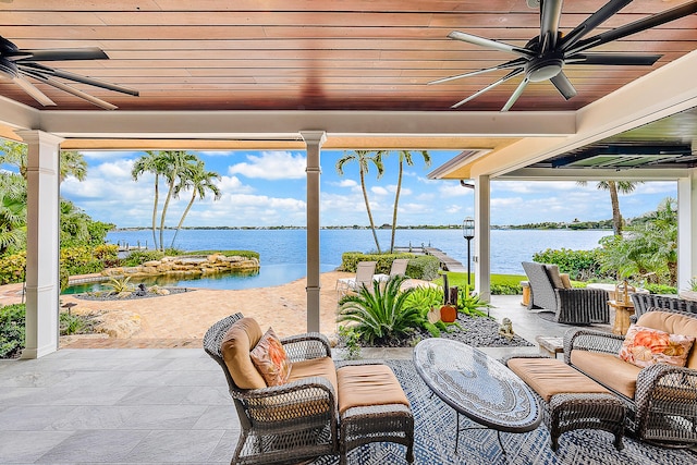 view of patio / terrace featuring outdoor lounge area, ceiling fan, and a water view