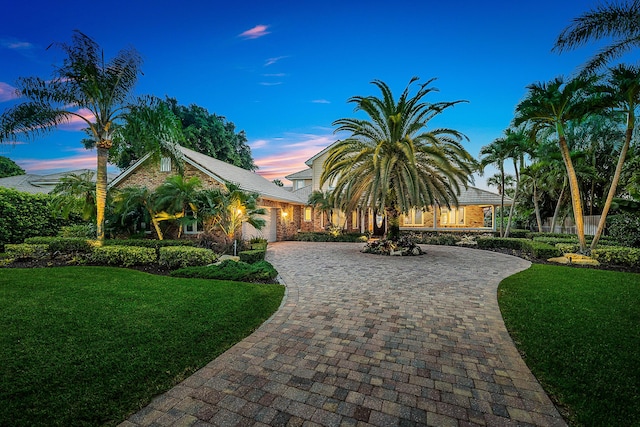 view of front of property featuring a lawn and a garage