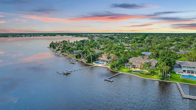 aerial view at dusk with a water view