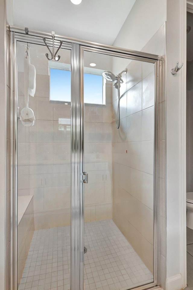 bathroom with a shower with shower door