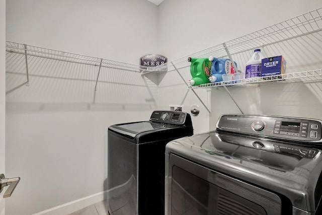 laundry area featuring tile patterned floors and washer and dryer