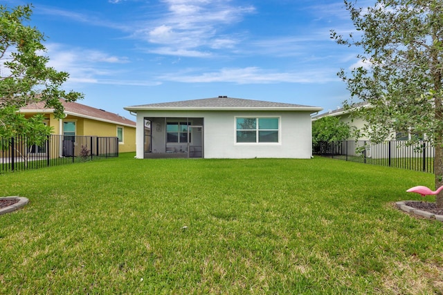 rear view of property featuring a yard