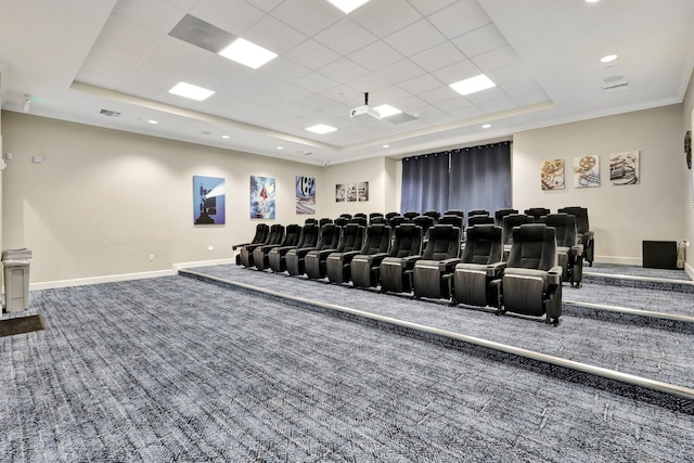 home theater with a raised ceiling, ornamental molding, carpet flooring, and a drop ceiling