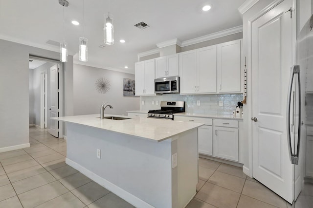 kitchen featuring pendant lighting, sink, appliances with stainless steel finishes, white cabinets, and a center island with sink