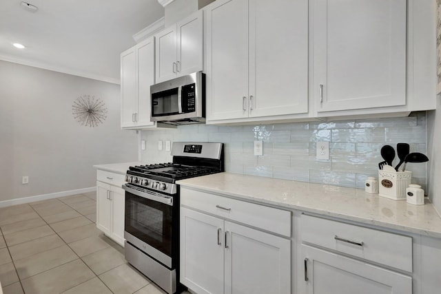 kitchen with white cabinetry, decorative backsplash, light tile patterned floors, light stone counters, and stainless steel appliances