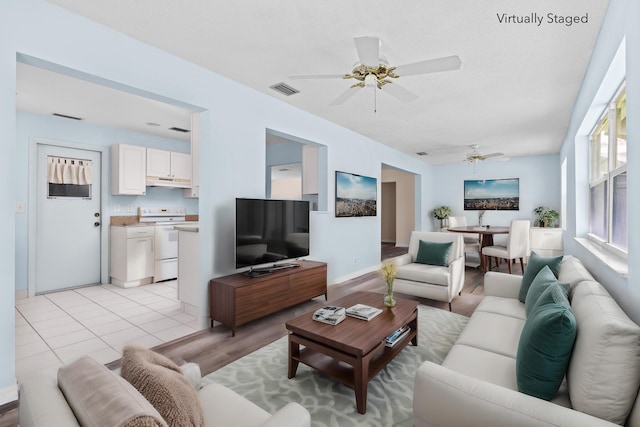 2078 SW 13th Ter, Boynton Beach, FL 33426 - living area with ceiling fan, light wood finished floors, and baseboards