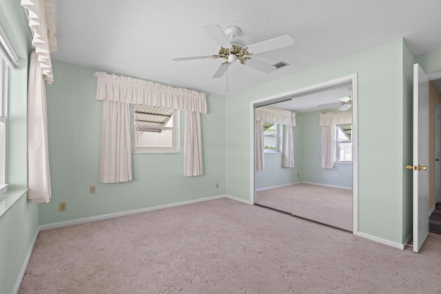 2078 SW 13th Ter, Boynton Beach, FL 33426 - unfurnished bedroom featuring carpet, a closet, a textured ceiling, ceiling fan, and baseboards