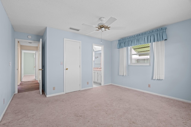 2078 SW 13th Ter, Boynton Beach, FL 33426 - unfurnished bedroom featuring carpet, baseboards, a textured ceiling, ensuite bathroom, and ceiling fan