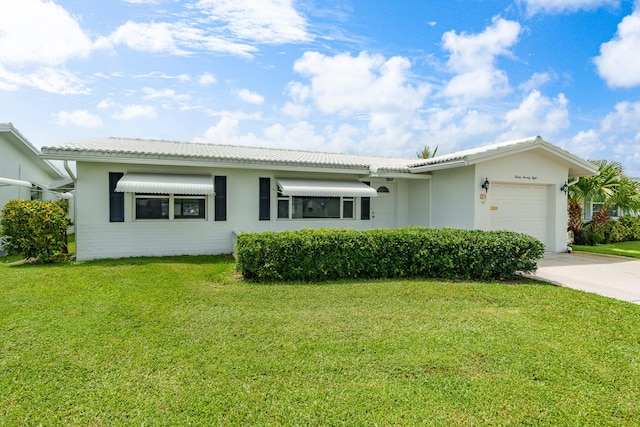 single story home featuring a garage, a front yard, driveway, and a tiled roof