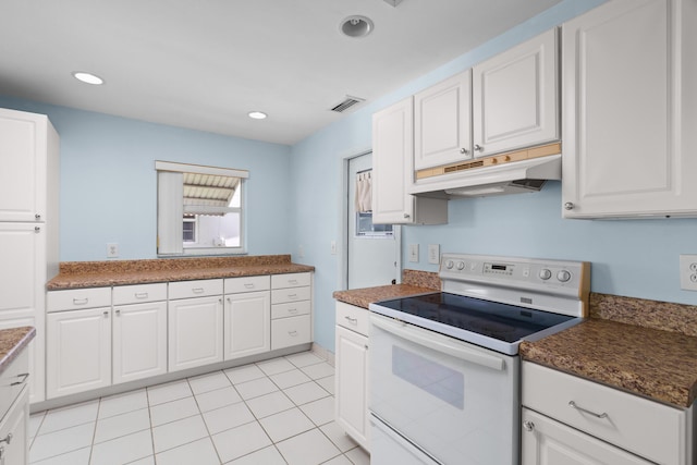 2078 SW 13th Ter, Boynton Beach, FL 33426 - kitchen with white electric stove, under cabinet range hood, white cabinets, recessed lighting, and light tile patterned floors