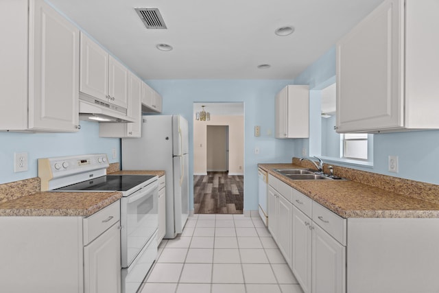 2078 SW 13th Ter, Boynton Beach, FL 33426 - kitchen featuring white appliances, a sink, under cabinet range hood, white cabinets, and light tile patterned flooring