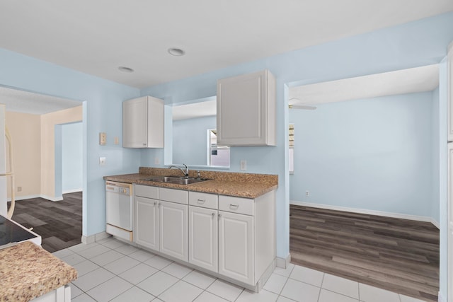2078 SW 13th Ter, Boynton Beach, FL 33426 - kitchen with white appliances, a sink, light wood-type flooring, baseboards, and white cabinetry