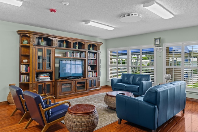 2078 SW 13th Ter, Boynton Beach, FL 33426 - living room with wood finished floors, a textured ceiling, and baseboards