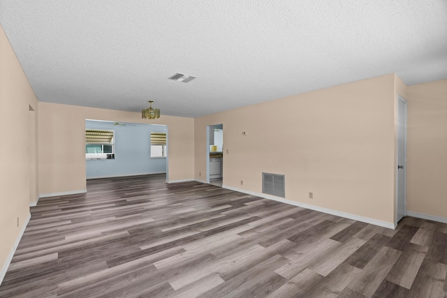 2078 SW 13th Ter, Boynton Beach, FL 33426 - unfurnished living room featuring wood finished floors, a textured ceiling, and baseboards