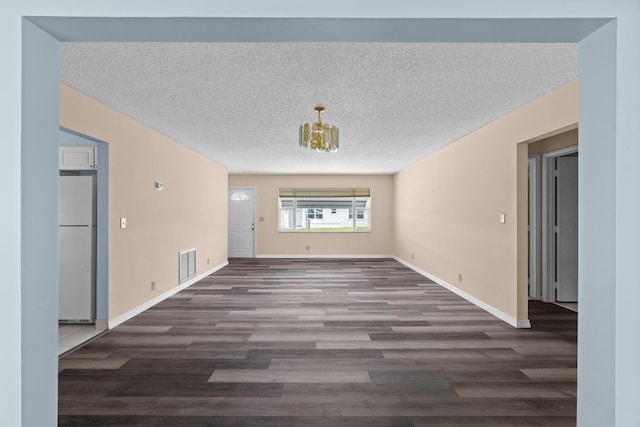 2078 SW 13th Ter, Boynton Beach, FL 33426 - unfurnished living room featuring wood finished floors, baseboards, a textured ceiling, and a chandelier