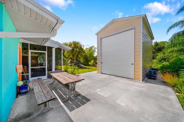 view of patio featuring an outbuilding