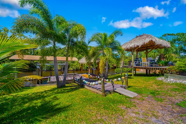 view of yard featuring a deck with water view and a gazebo