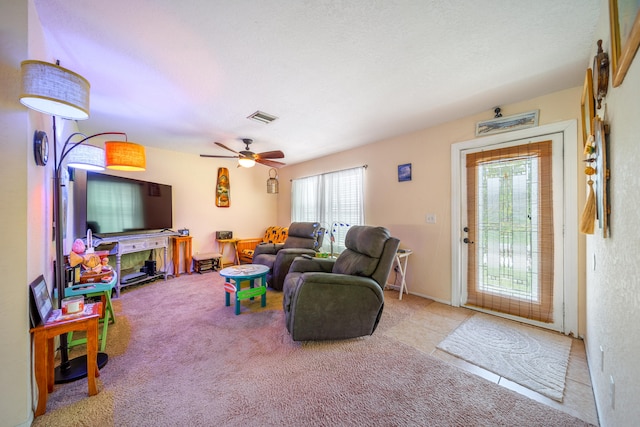 living room featuring ceiling fan and light carpet