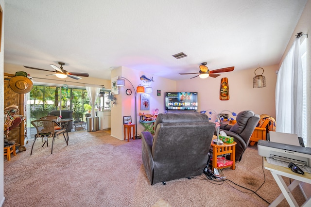 living room with ceiling fan and carpet flooring