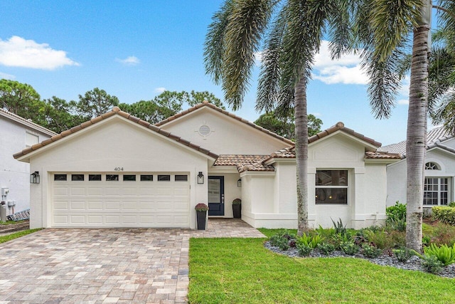 view of front of home with a front lawn and a garage