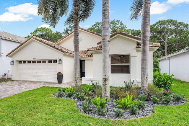 mediterranean / spanish-style home with a front lawn and a garage