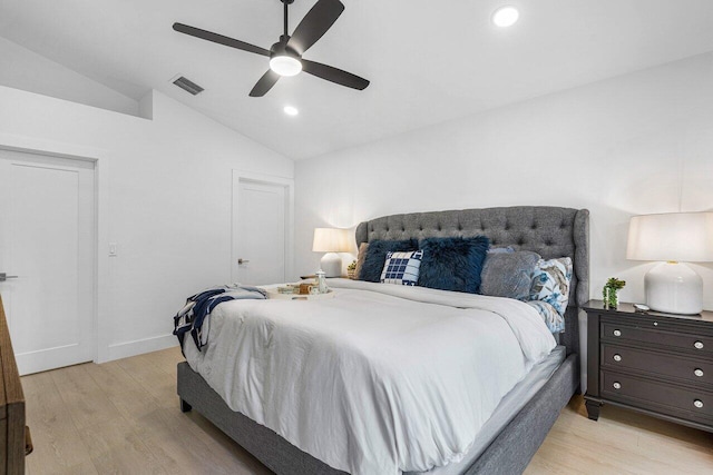 bedroom with ceiling fan, lofted ceiling, and light hardwood / wood-style floors