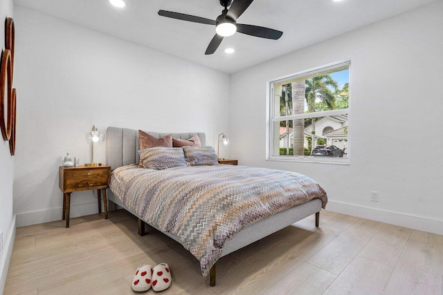 bedroom with ceiling fan and light hardwood / wood-style floors