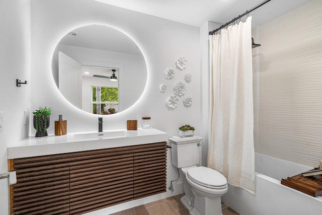 full bathroom with shower / bathtub combination with curtain, toilet, vanity, and ceiling fan