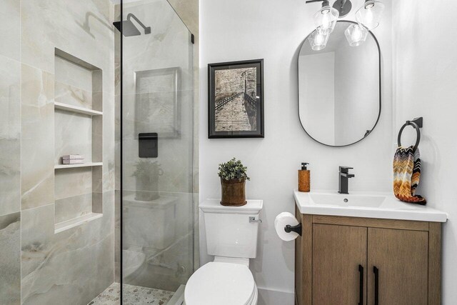 bathroom featuring vanity, toilet, and an enclosed shower