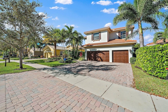 mediterranean / spanish-style house with a garage