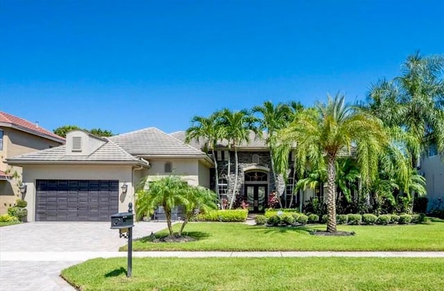 view of front of home with a garage and a front yard