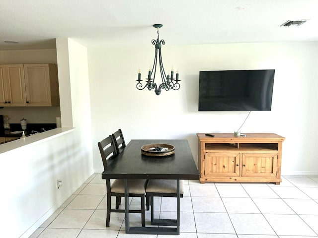 dining room featuring an inviting chandelier and light tile patterned floors