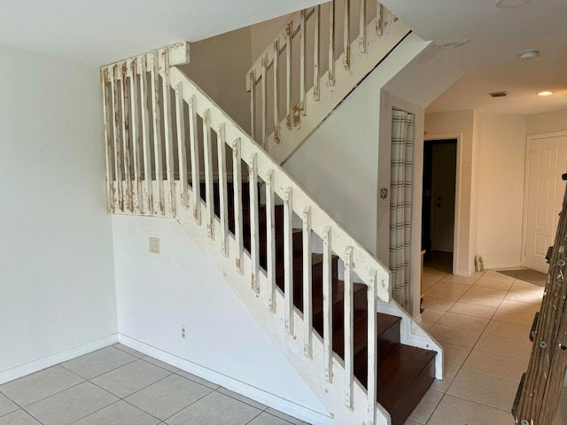 staircase with tile patterned floors