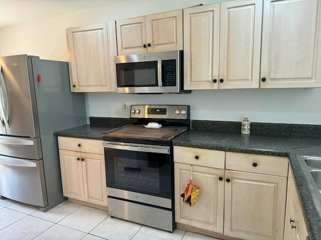 kitchen with light tile patterned flooring and stainless steel appliances