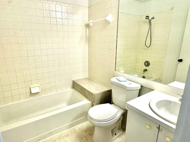 full bathroom with tiled shower / bath, vanity, and toilet