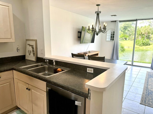 kitchen with hanging light fixtures, light tile patterned floors, sink, kitchen peninsula, and a chandelier