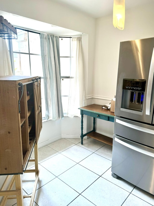 kitchen featuring light tile patterned flooring, wood counters, and stainless steel fridge with ice dispenser