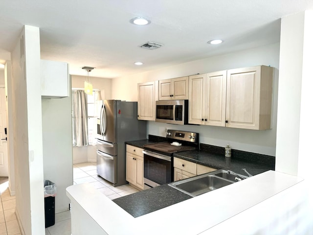 kitchen with sink, light tile patterned floors, stainless steel appliances, and decorative light fixtures