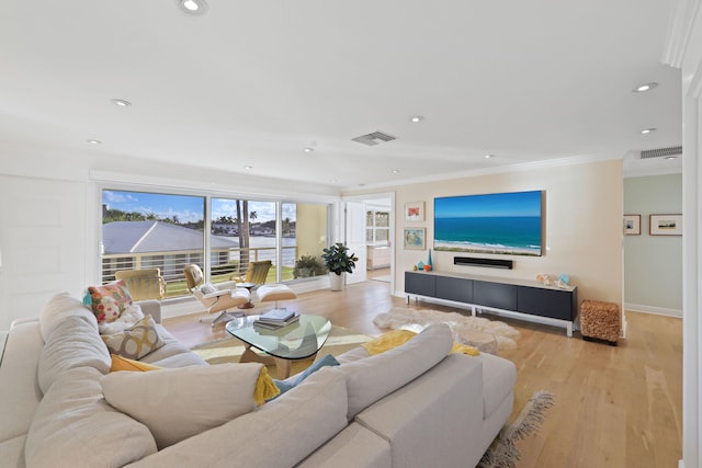 living room featuring light wood-type flooring and ornamental molding