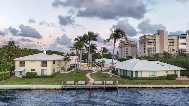 exterior space featuring a water view and a lawn