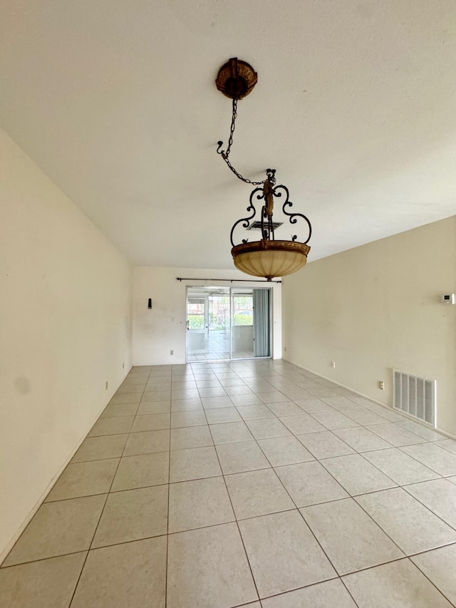 spare room featuring light tile patterned flooring