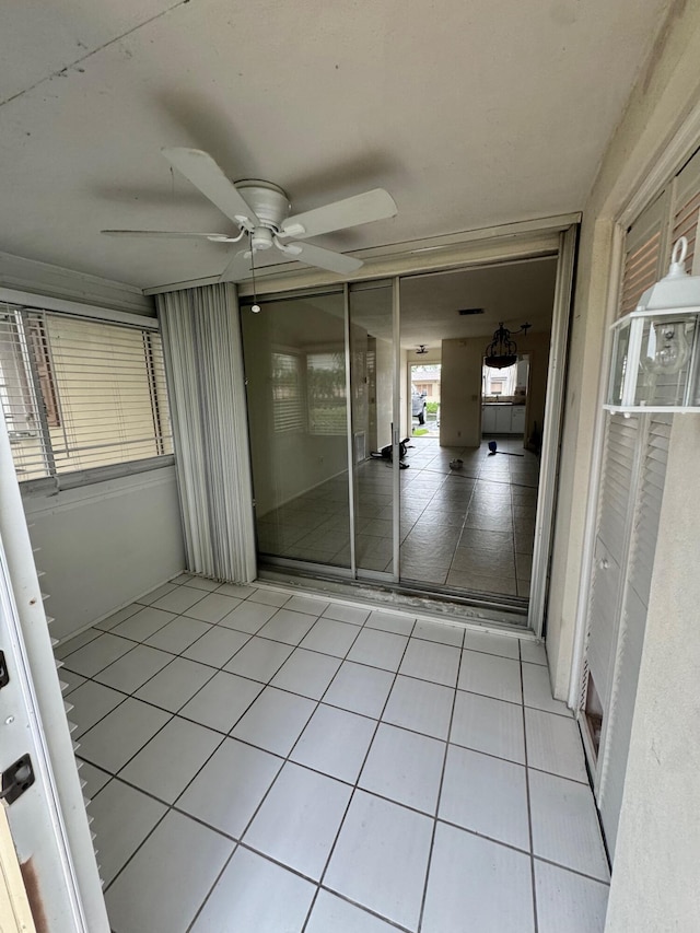 interior space featuring light tile patterned flooring and ceiling fan