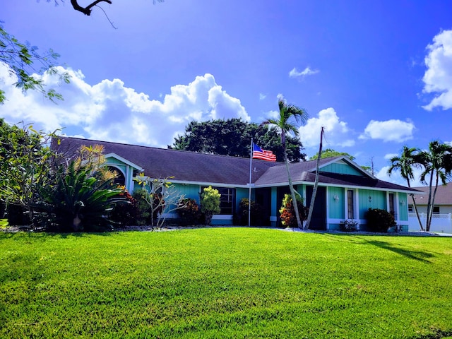 ranch-style house featuring a front lawn