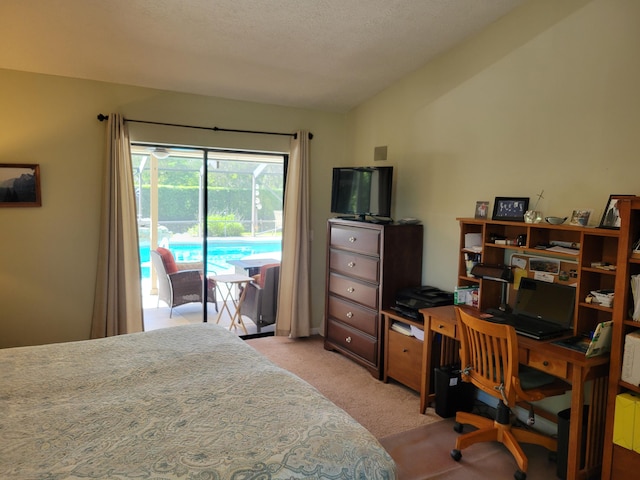 carpeted bedroom with lofted ceiling, a textured ceiling, and access to outside