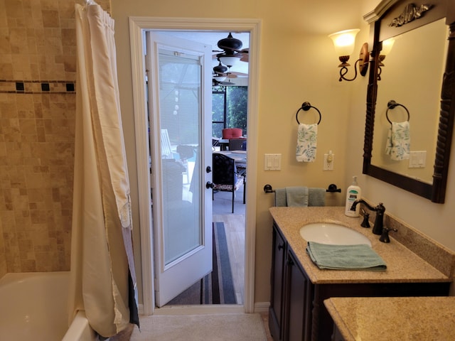 bathroom featuring shower / bath combo and vanity