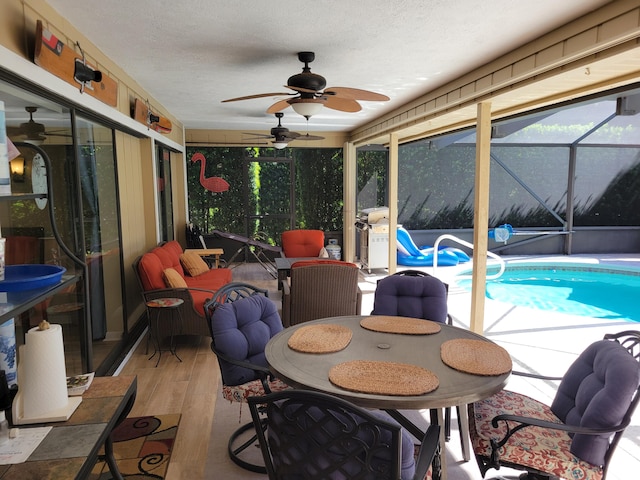 exterior space featuring area for grilling, ceiling fan, and a lanai